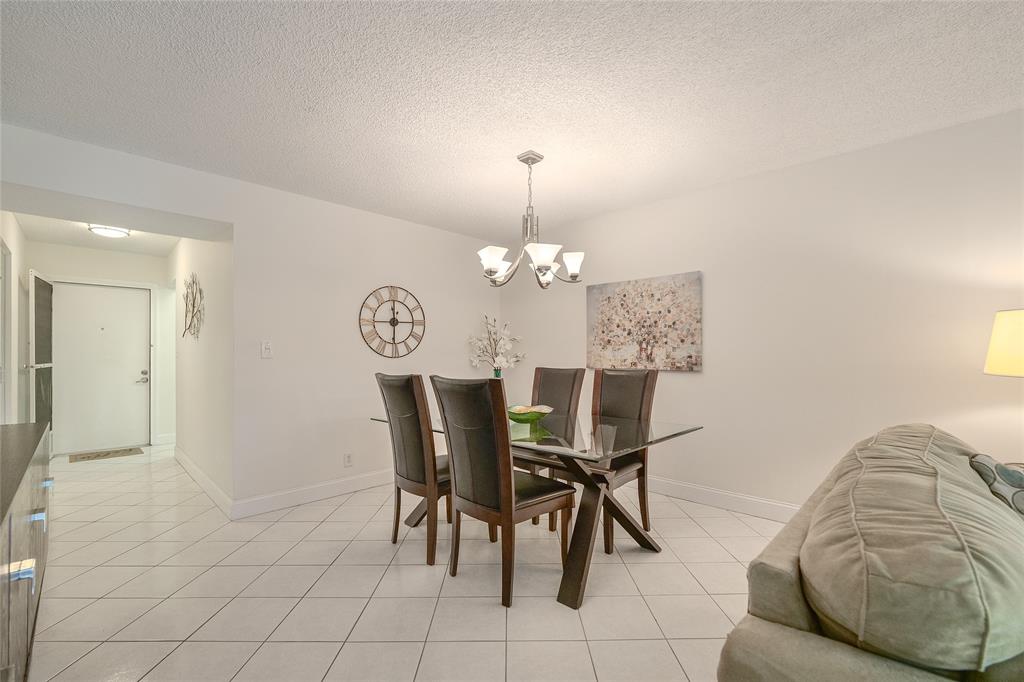 6100 Northwest 44th Street, Unit 307 Lauderhill, FL 33319 - Photo 6 of 54 a view of a dining room with furniture and a chandelier