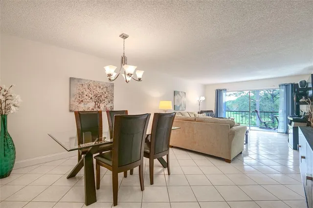 a dining room with furniture and a chandelier