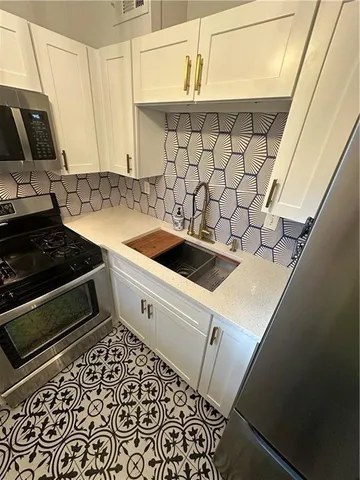 a kitchen with a sink and cabinets