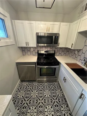 a kitchen with a stove and a microwave