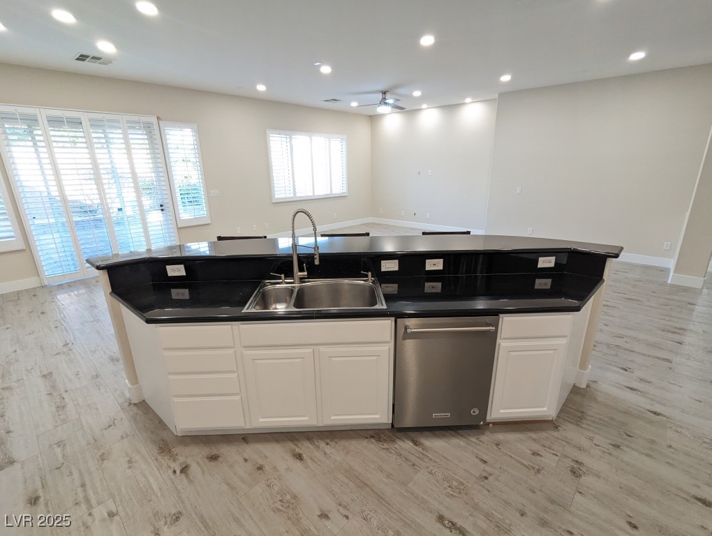 9976 Liberty View Road Las Vegas, NV 89148 - Photo 44 of 44 Kitchen with white cabinets, open floor plan, an island with sink, and recessed lighting
