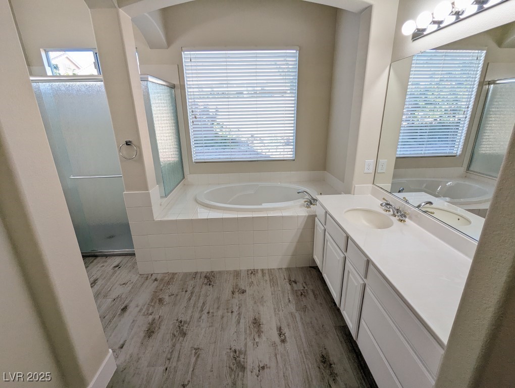 9976 Liberty View Road Las Vegas, NV 89148 - Photo 16 of 44 Bathroom featuring a garden tub, vanity, and healthy amount of natural light