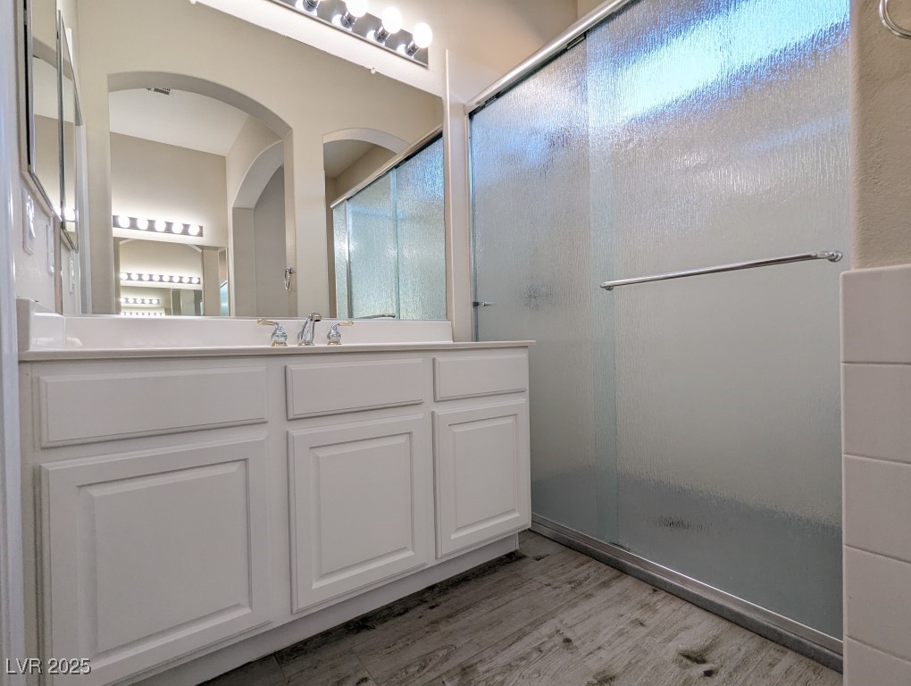 9976 Liberty View Road Las Vegas, NV 89148 - Photo 17 of 44 Full bath with vanity, a stall shower, and light wood finished floors