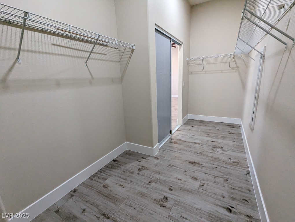 9976 Liberty View Road Las Vegas, NV 89148 - Photo 19 of 44 Spacious closet with light wood-style flooring