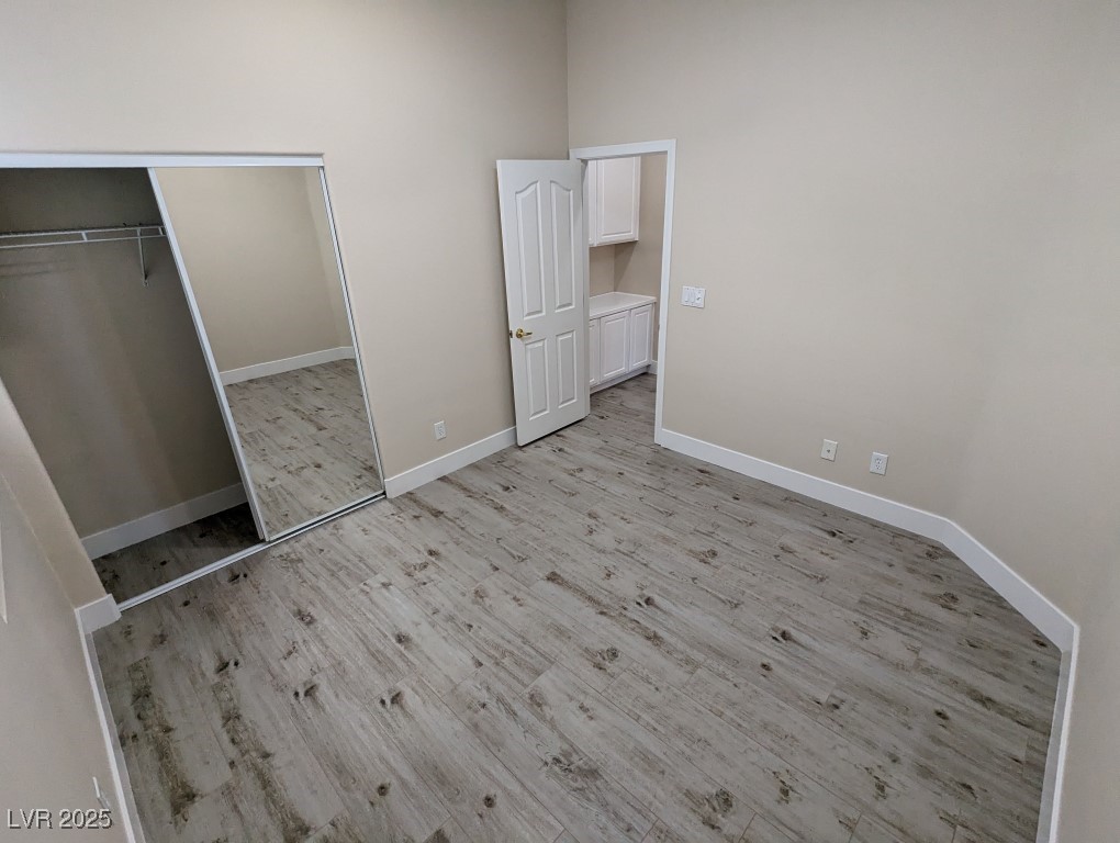 9976 Liberty View Road Las Vegas, NV 89148 - Photo 22 of 44 Unfurnished bedroom featuring light wood finished floors and a closet