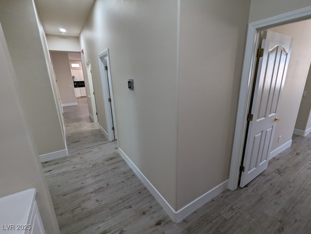 9976 Liberty View Road Las Vegas, NV 89148 - Photo 23 of 44 Corridor featuring light wood-style floors
