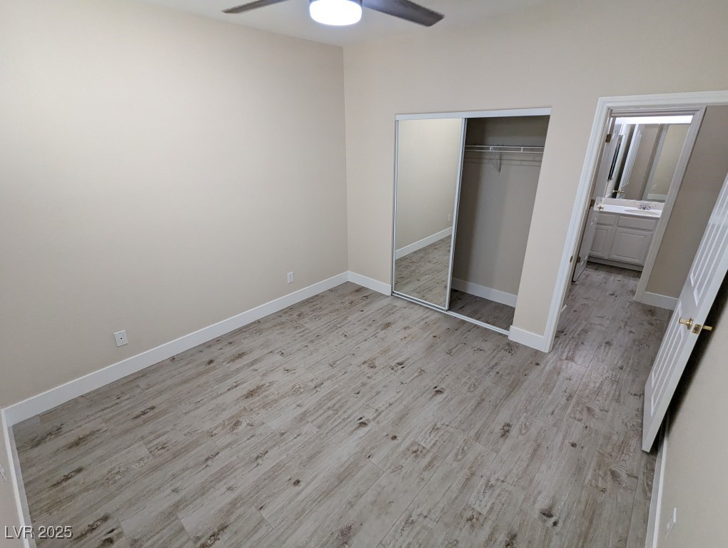 9976 Liberty View Road Las Vegas, NV 89148 - Photo 24 of 44 Unfurnished bedroom with a closet, light wood-type flooring, and ceiling fan