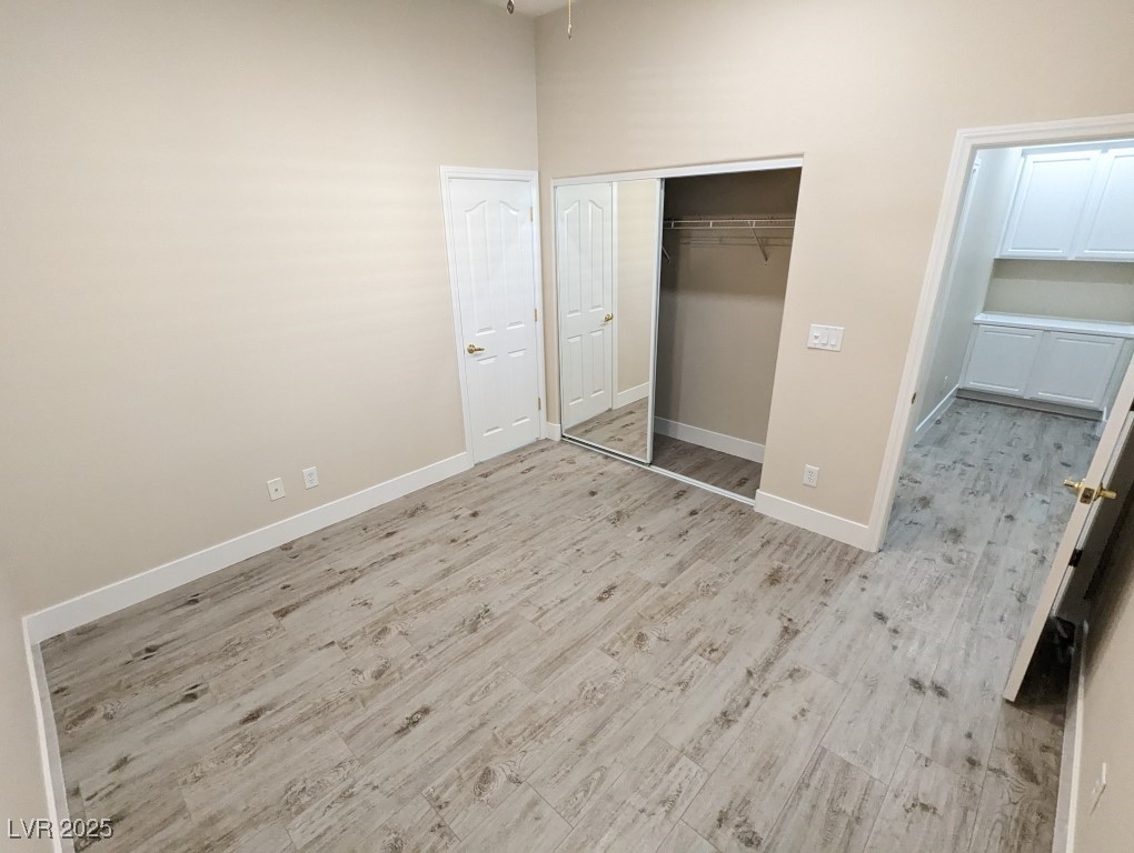 9976 Liberty View Road Las Vegas, NV 89148 - Photo 31 of 44 Unfurnished bedroom with light wood finished floors and a closet
