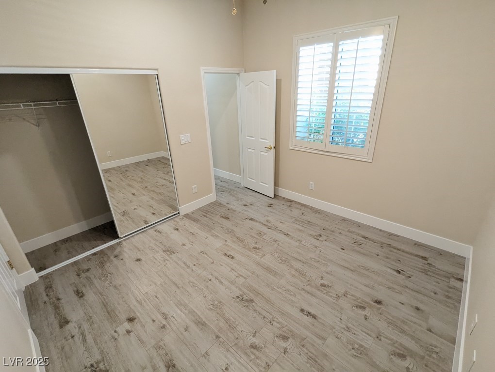 9976 Liberty View Road Las Vegas, NV 89148 - Photo 32 of 44 Unfurnished bedroom featuring light wood-type flooring and a closet