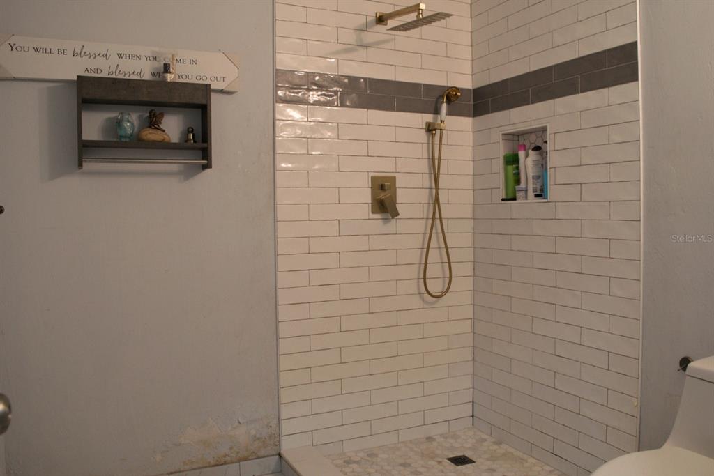 10607 Fernando Street Orlando, FL 32825 - Photo 11 of 19 a bathroom with a shower