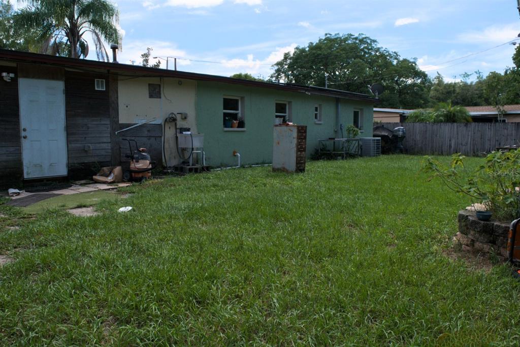 10607 Fernando Street Orlando, FL 32825 - Photo 16 of 19 a backyard of a house with table and chairs and potted plants