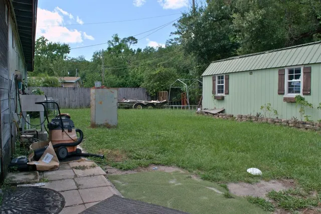 a view of a backyard with plants and a garden