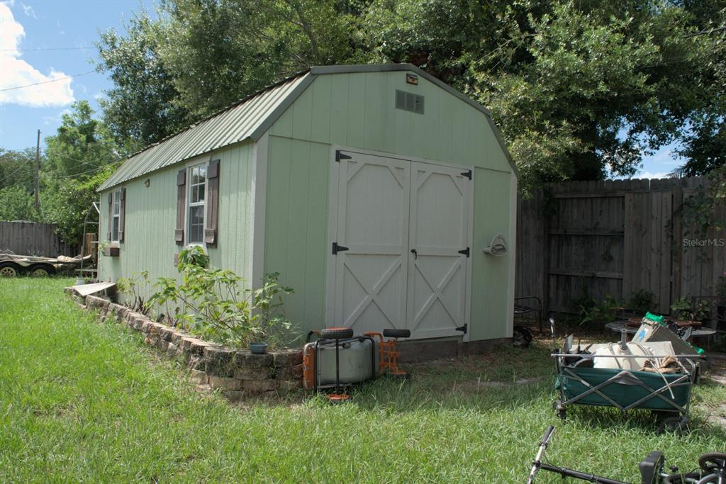 10607 Fernando Street Orlando, FL 32825 - Photo 18 of 19 a view of a small house with garden