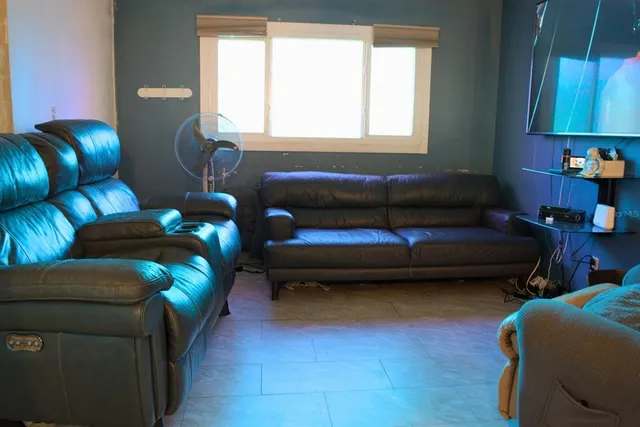 a living room with furniture and a window