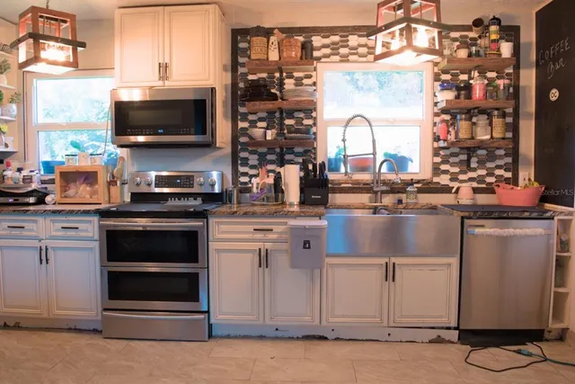 a kitchen with appliances a sink and a stove
