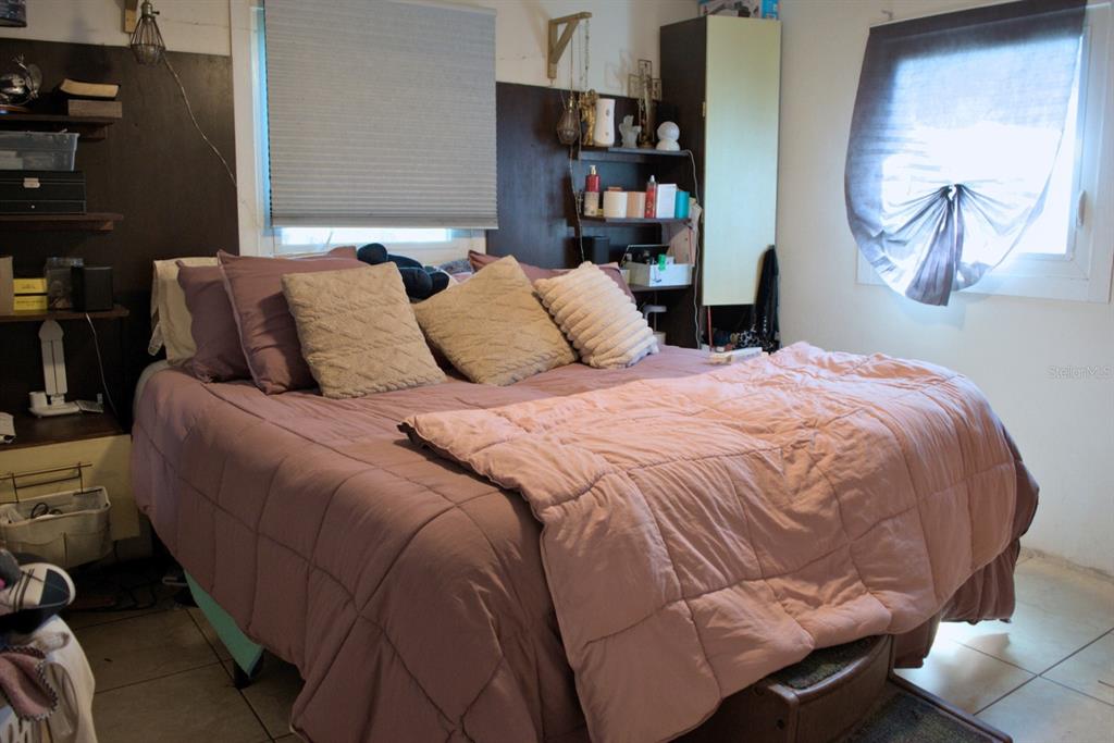 10607 Fernando Street Orlando, FL 32825 - Photo 10 of 19 a bed sitting in a bedroom next to a window