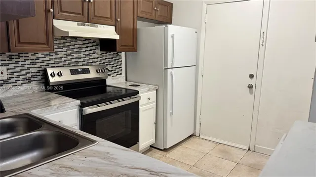 a kitchen with a stove and a refrigerator