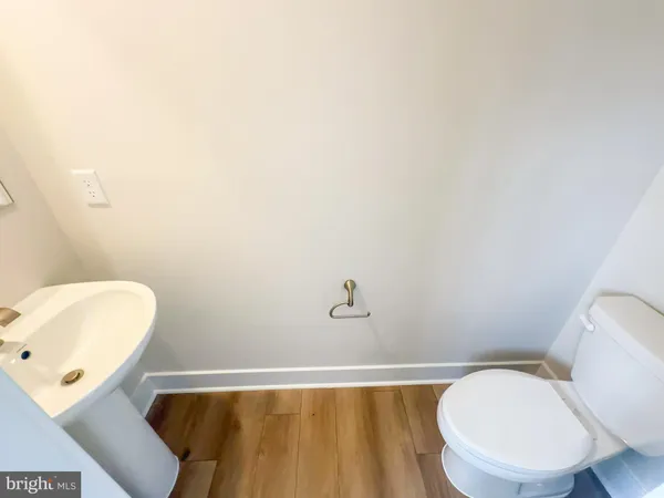 a white toilet sitting next to a bathroom sink