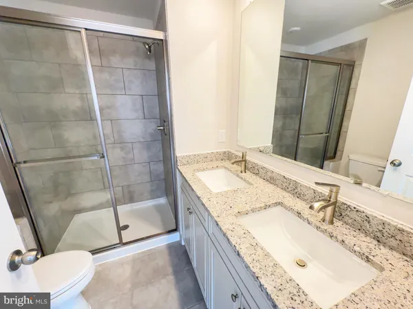 a bathroom with a sink a toilet and bathtub