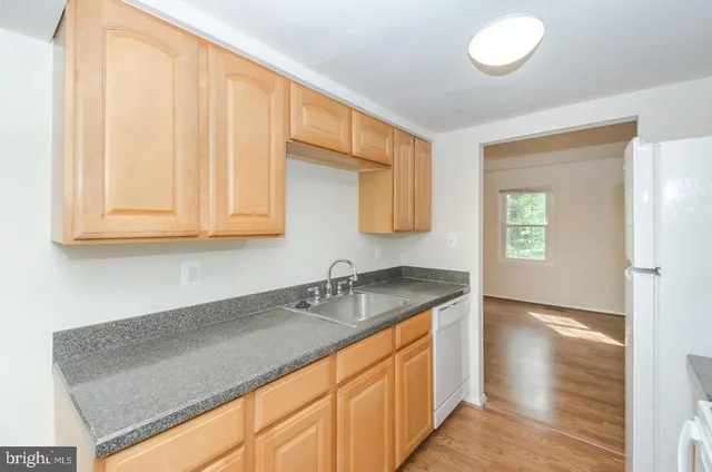 a kitchen with granite countertop cabinets and sink