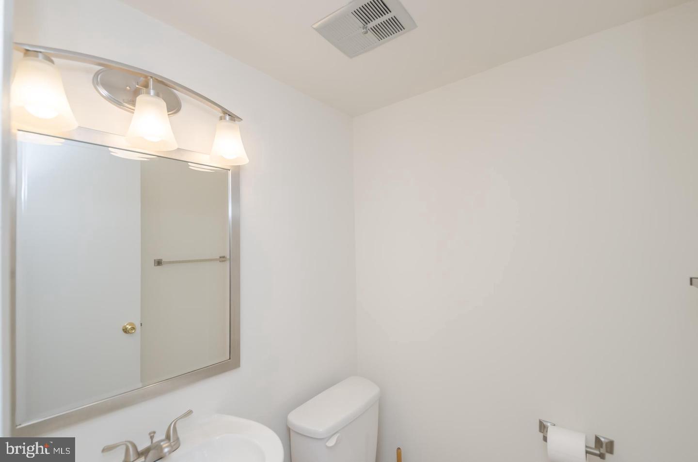 1822 Foxdale Court Crofton, MD 21114 - Photo 18 of 38 a bathroom with a toilet and a mirror