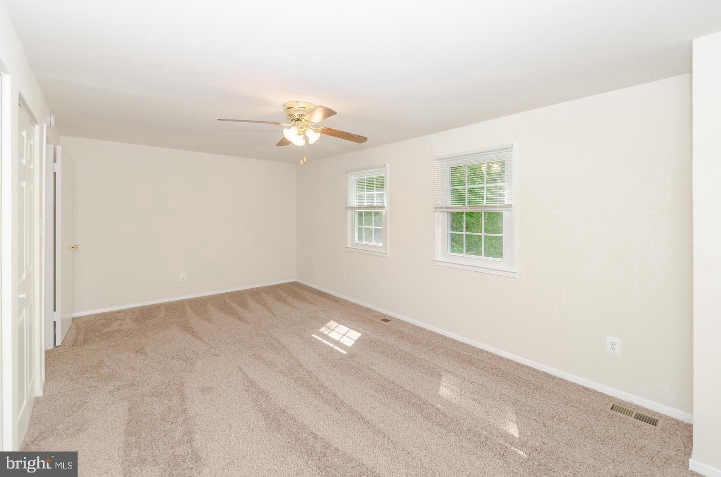 1822 Foxdale Court Crofton, MD 21114 - Photo 24 of 38 an empty room with windows and ceiling fan