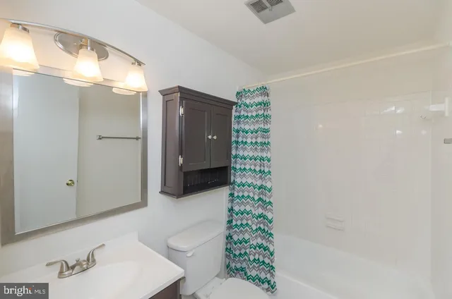 a bathroom with a shower and a sink