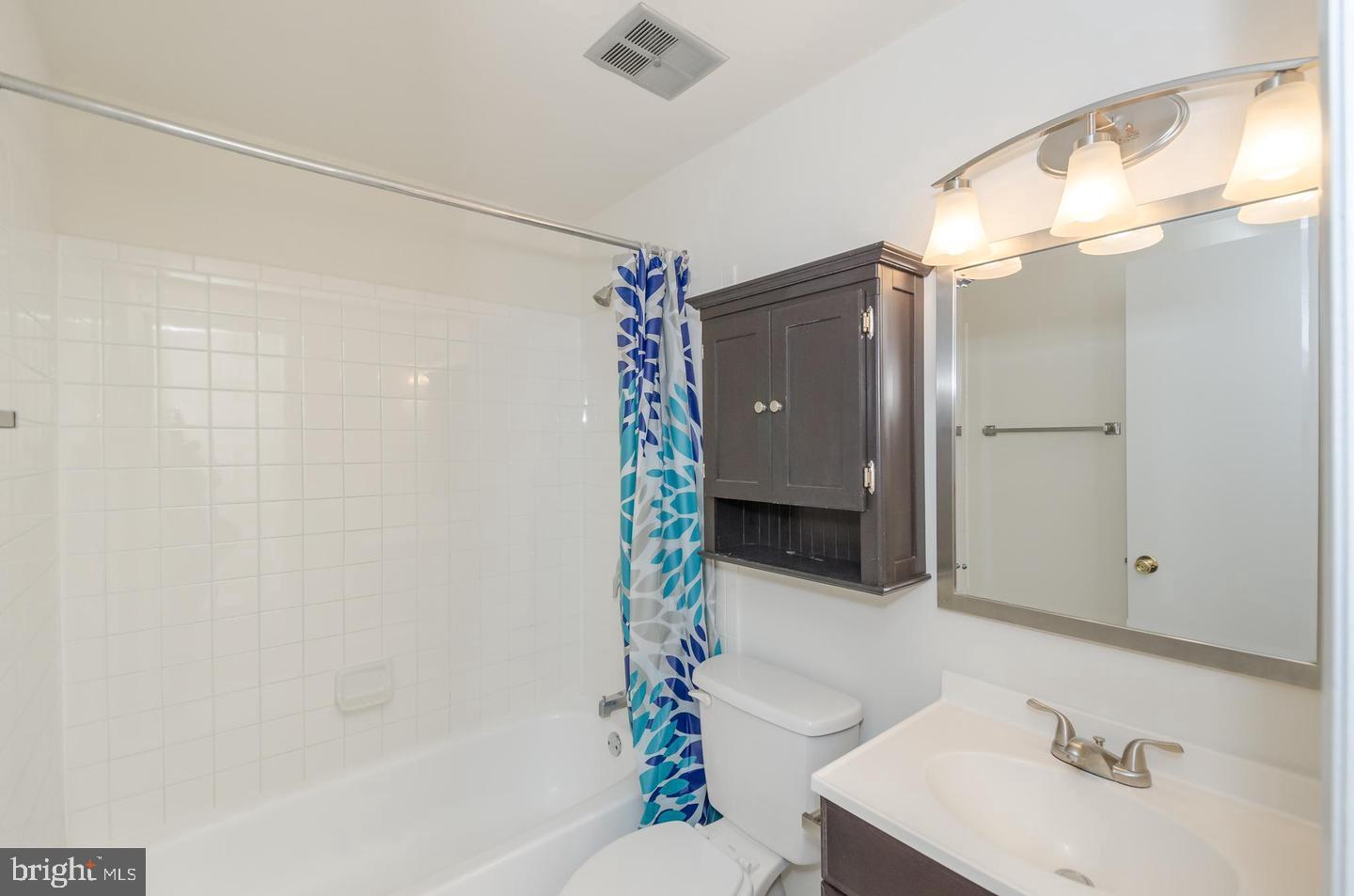 1822 Foxdale Court Crofton, MD 21114 - Photo 30 of 38 a bathroom with a sink vanity mirror and shower