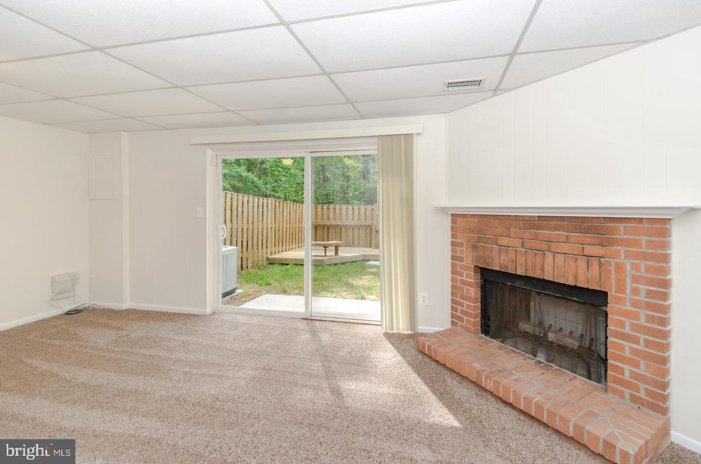 1822 Foxdale Court Crofton, MD 21114 - Photo 34 of 38 a view of an empty room with windows and a fireplace