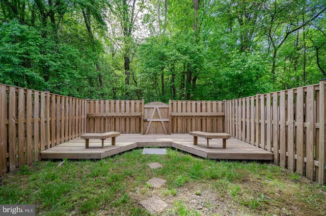 a view of a chair and table in backyard