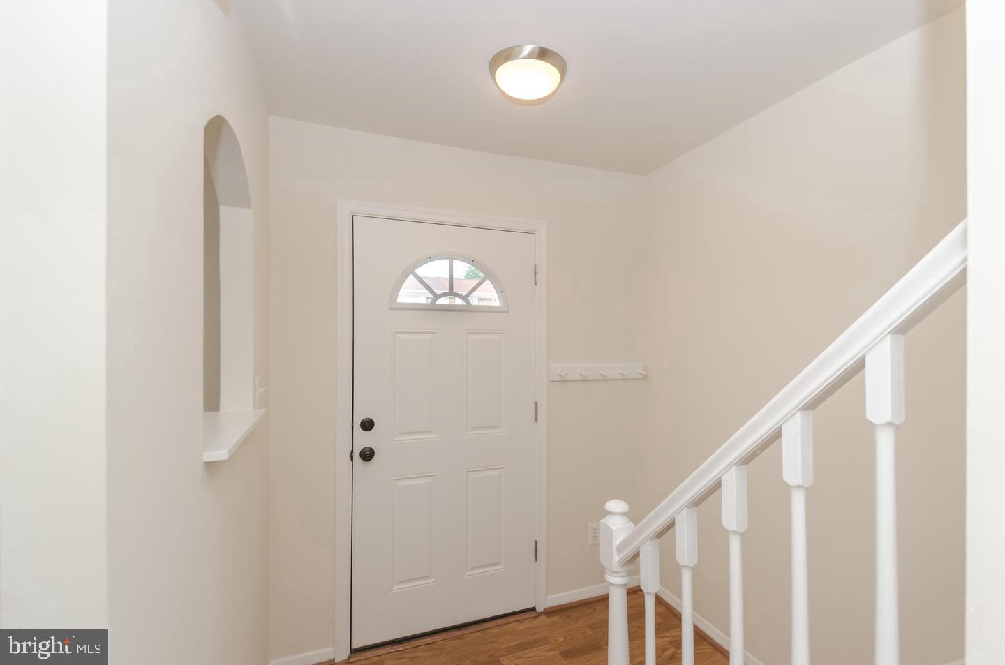 1822 Foxdale Court Crofton, MD 21114 - Photo 10 of 38 a view of a hallway with wooden floor and staircase