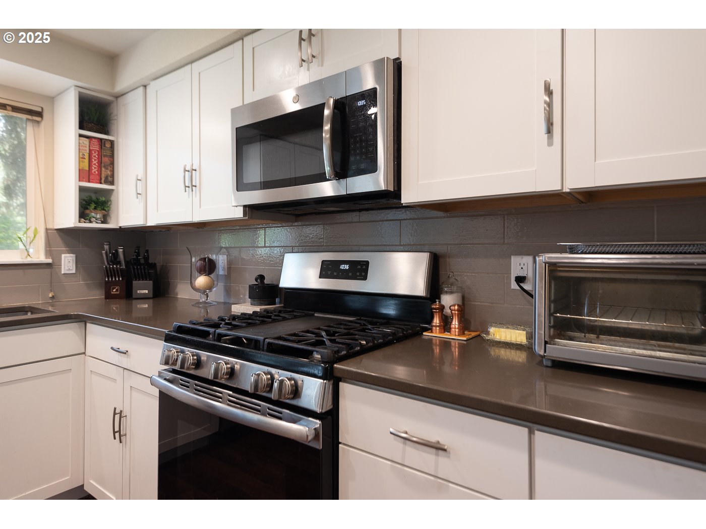 60811 Windsor Drive Bend, OR 97702 - Photo 7 of 27 a kitchen with stainless steel appliances granite countertop white cabinets a stove top oven and granite counter tops