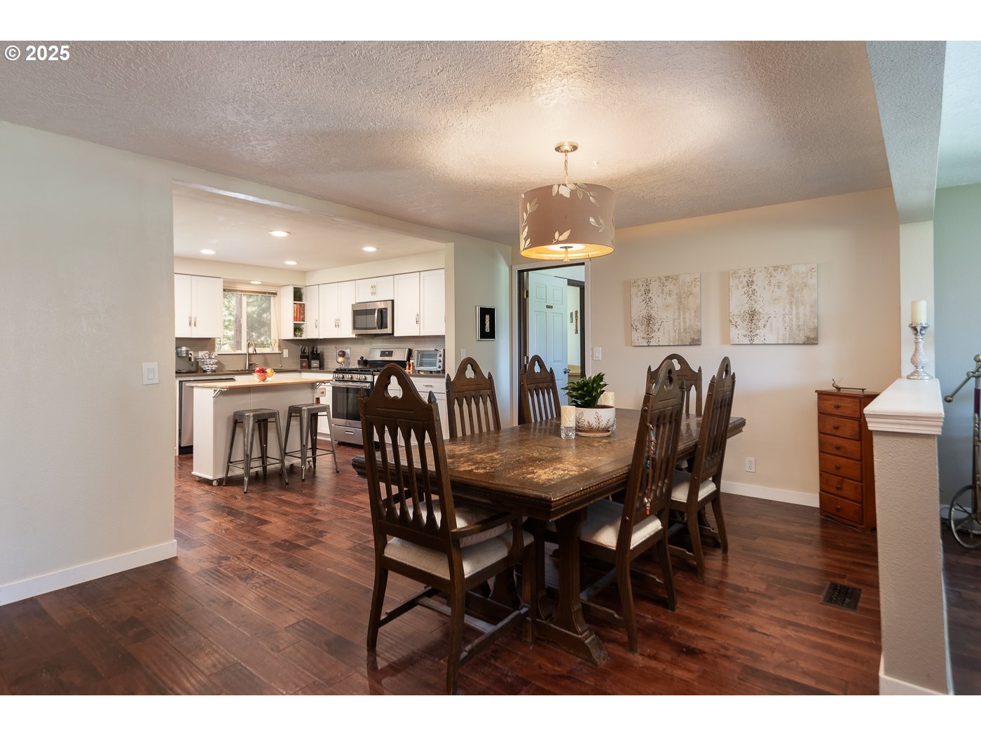 60811 Windsor Drive Bend, OR 97702 - Photo 10 of 27 a view of a dining room with furniture and wooden floor