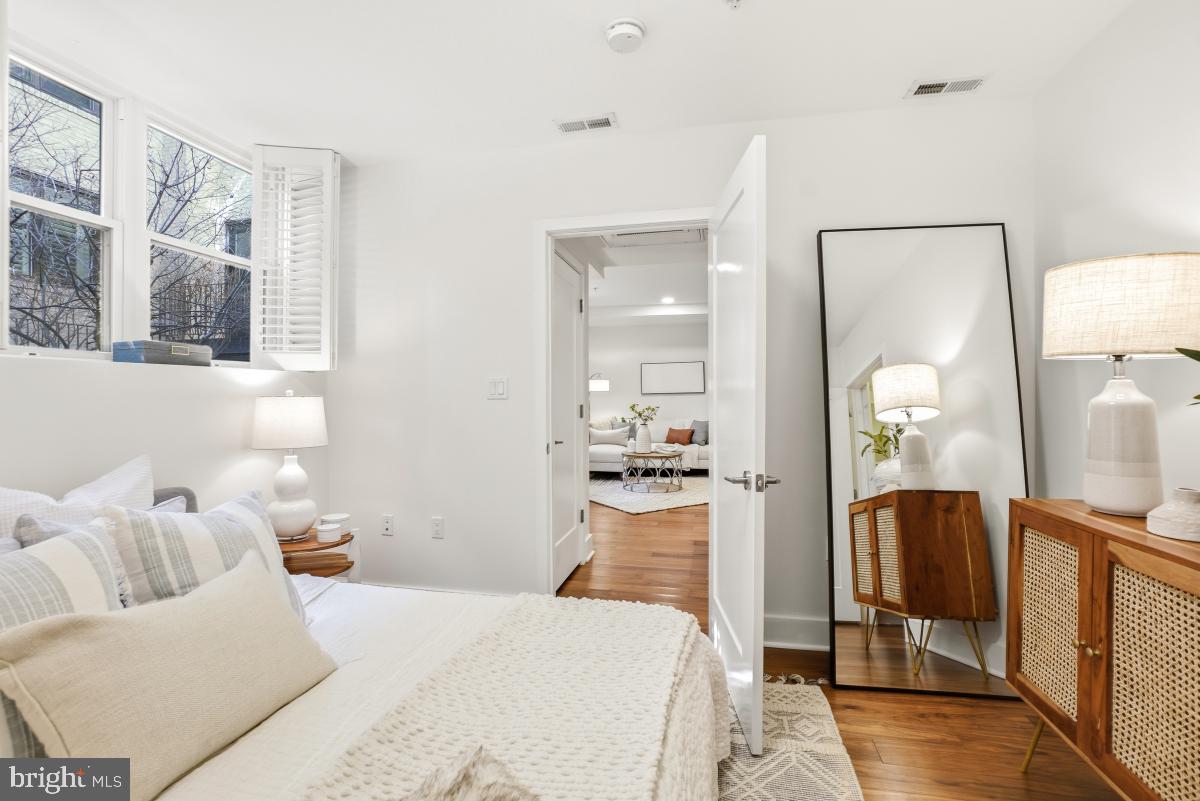 2331 15th Street Northwest, Unit 108N Washington, DC 20009 - Photo 11 of 25 a bedroom with a bed and wooden floor