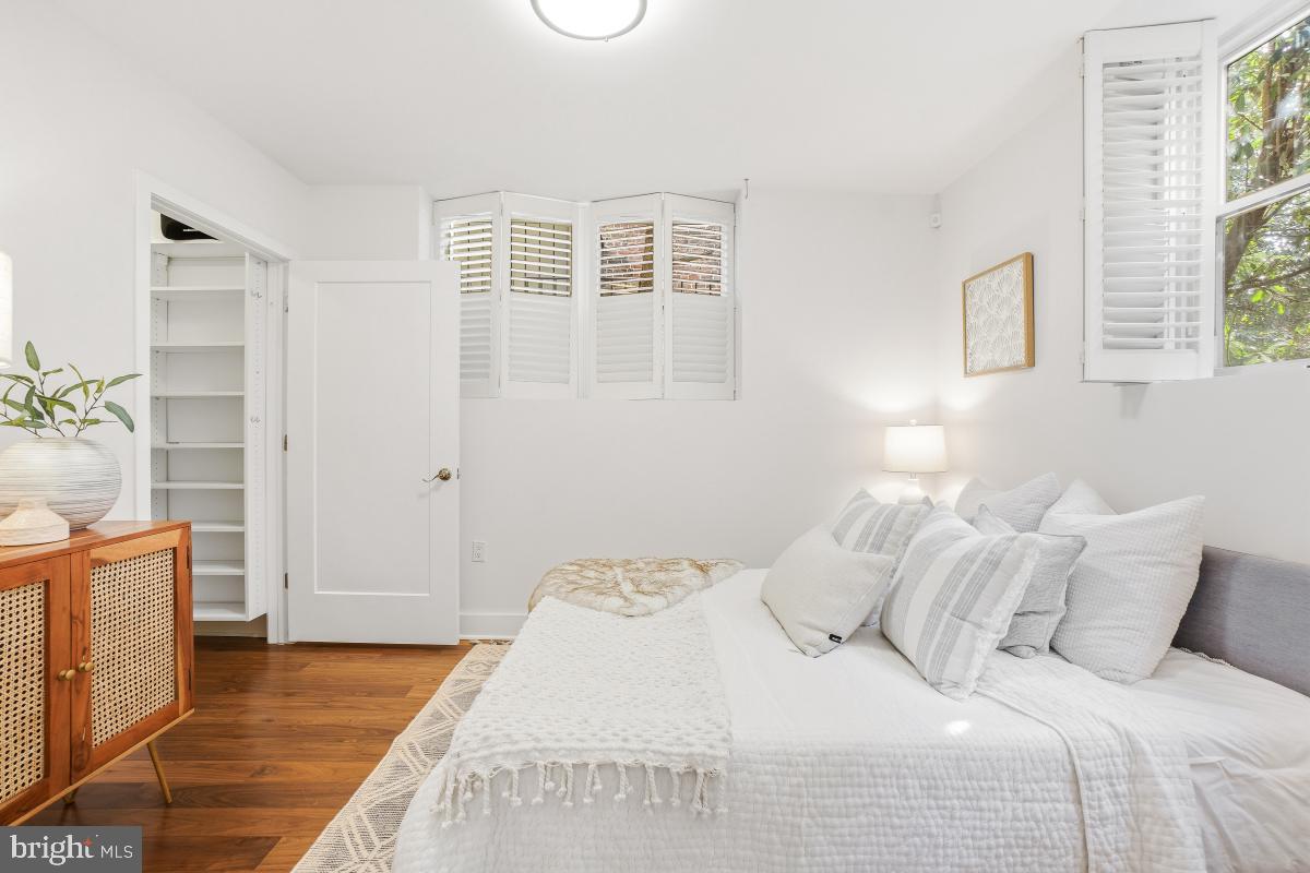 2331 15th Street Northwest, Unit 108N Washington, DC 20009 - Photo 12 of 25 a bedroom with a large bed and wooden floor