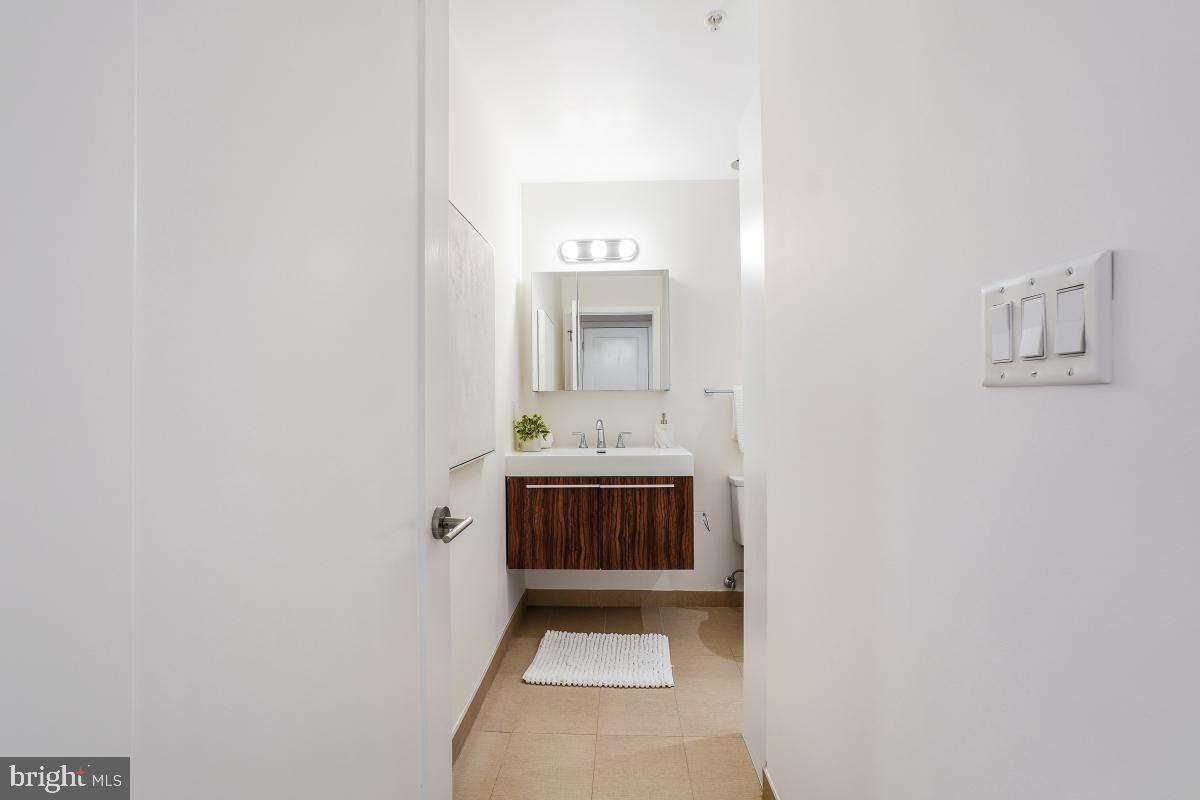 2331 15th Street Northwest, Unit 108N Washington, DC 20009 - Photo 14 of 25 a bathroom with a sink and a mirror