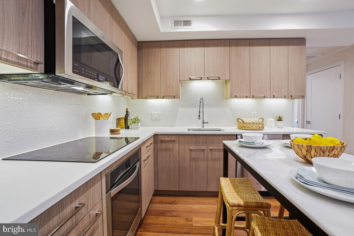 2331 15th Street Northwest, Unit 108N Washington, DC 20009 - Photo 2 of 25 a kitchen with stainless steel appliances granite countertop a sink a stove and a cabinets