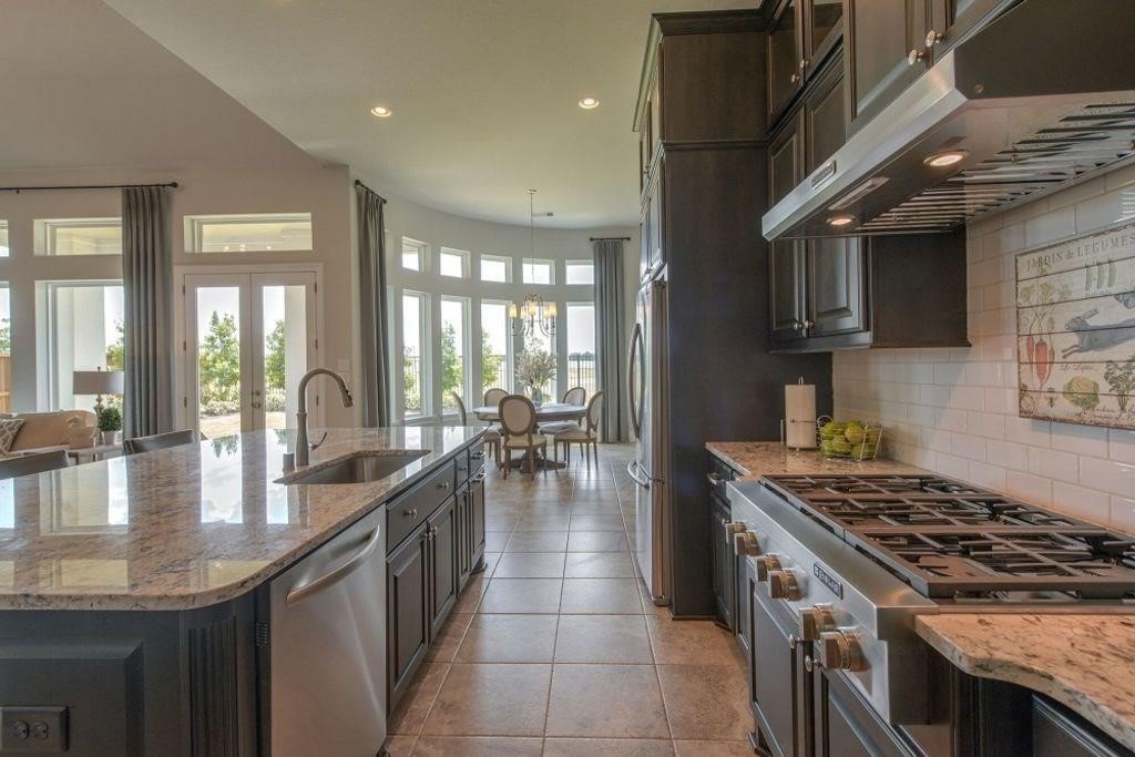26519 Ashley Ridge Lane Katy, TX 77494 - Photo 12 of 28 a kitchen with granite countertop a stove and a sink