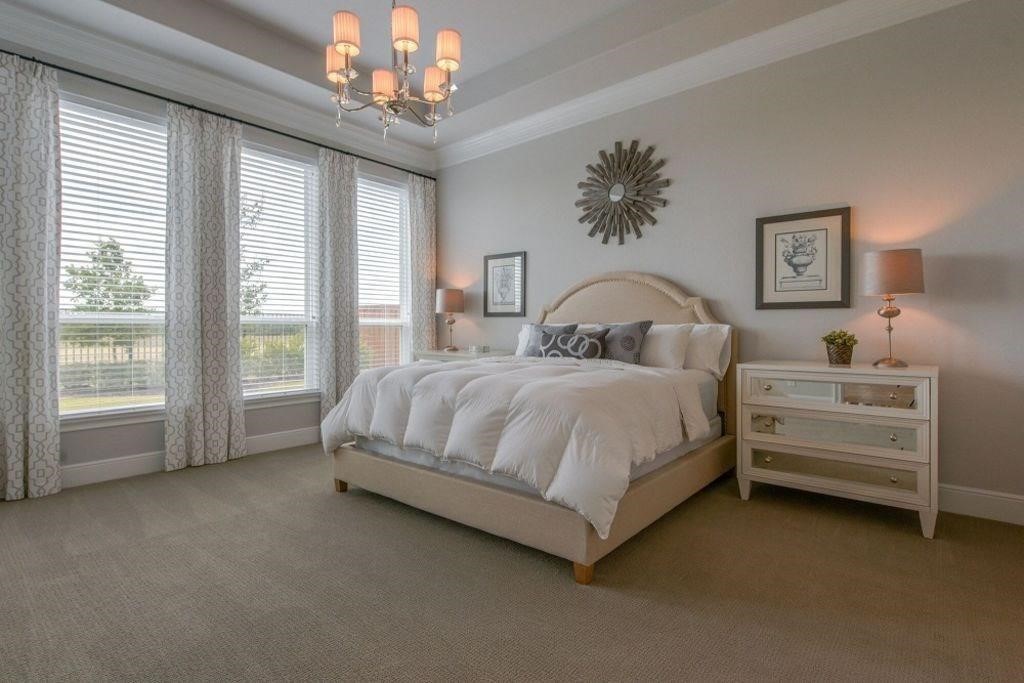 26519 Ashley Ridge Lane Katy, TX 77494 - Photo 15 of 28 a spacious bedroom with a bed and a chandelier