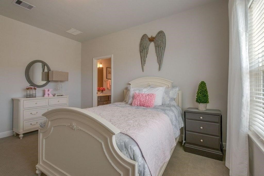 26519 Ashley Ridge Lane Katy, TX 77494 - Photo 20 of 28 a bedroom with a bed and a dresser