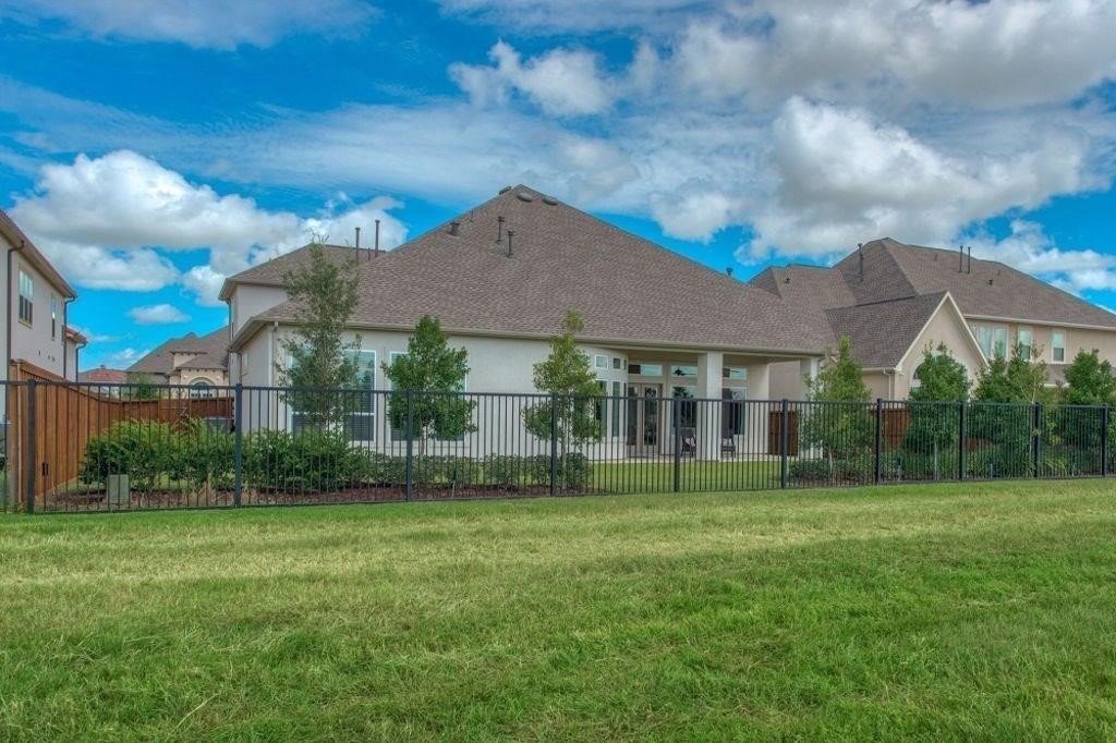 26519 Ashley Ridge Lane Katy, TX 77494 - Photo 26 of 28 a view of a white house next to a yard with big trees