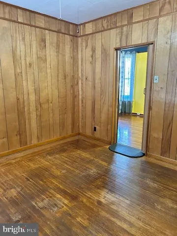 a view of a room with wooden floor