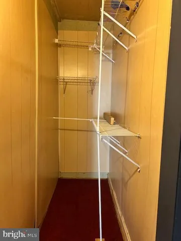 a view of room with wooden floor and windows