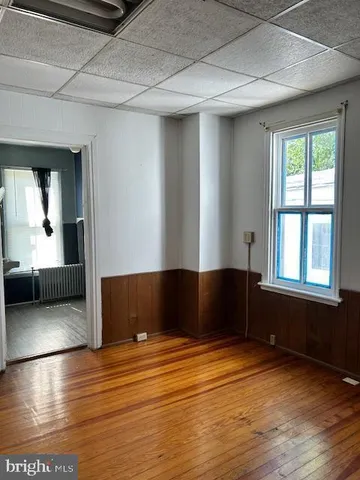 a view of a room with wooden floor