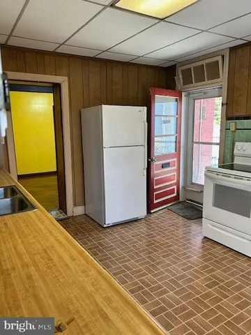 a white refrigerator freezer sitting inside of a kitchen