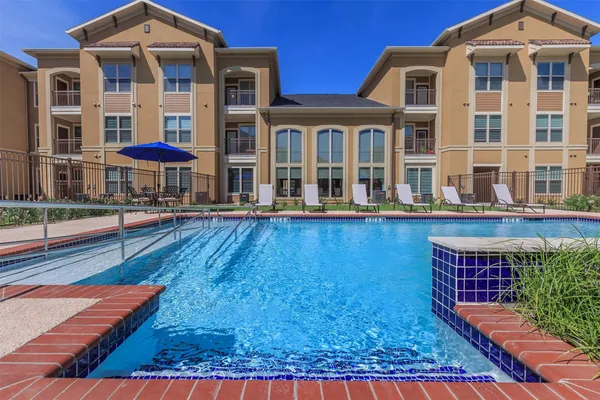 a kitchen with stainless steel appliances granite countertop a table chairs and wooden floor