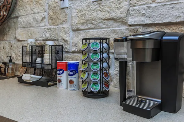 an empty room with wooden floor cabinet and windows