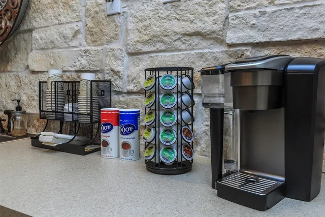 an empty room with wooden floor cabinet and windows