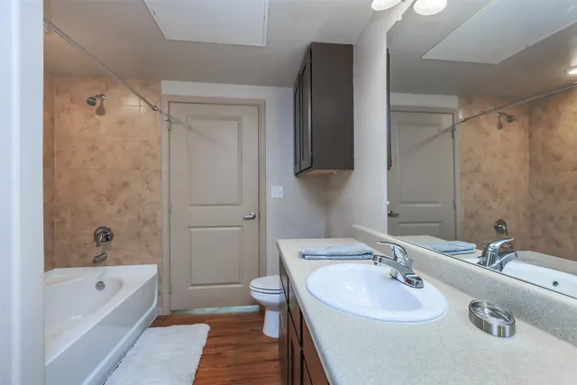 a bathroom with a white bath tub and a shower