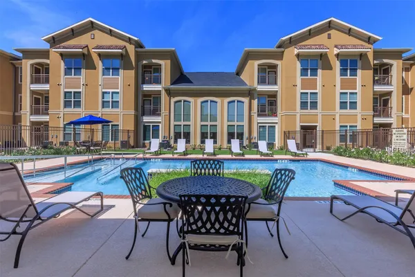 a view of a chairs and table in the patio
